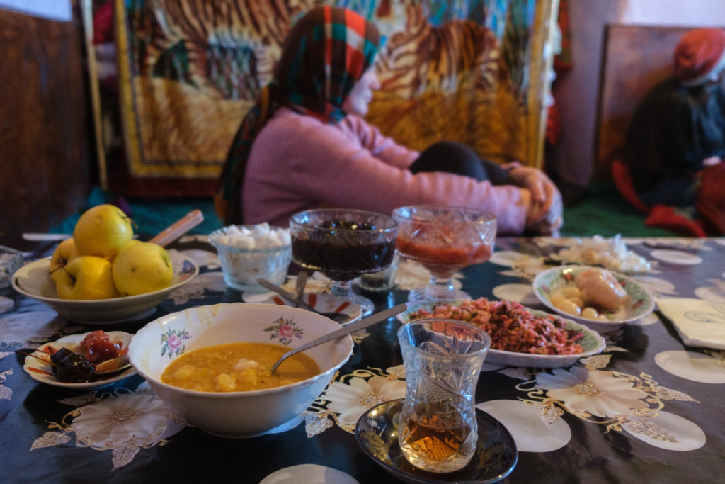 A person sitting at a table with a plate of food

Description automatically generated